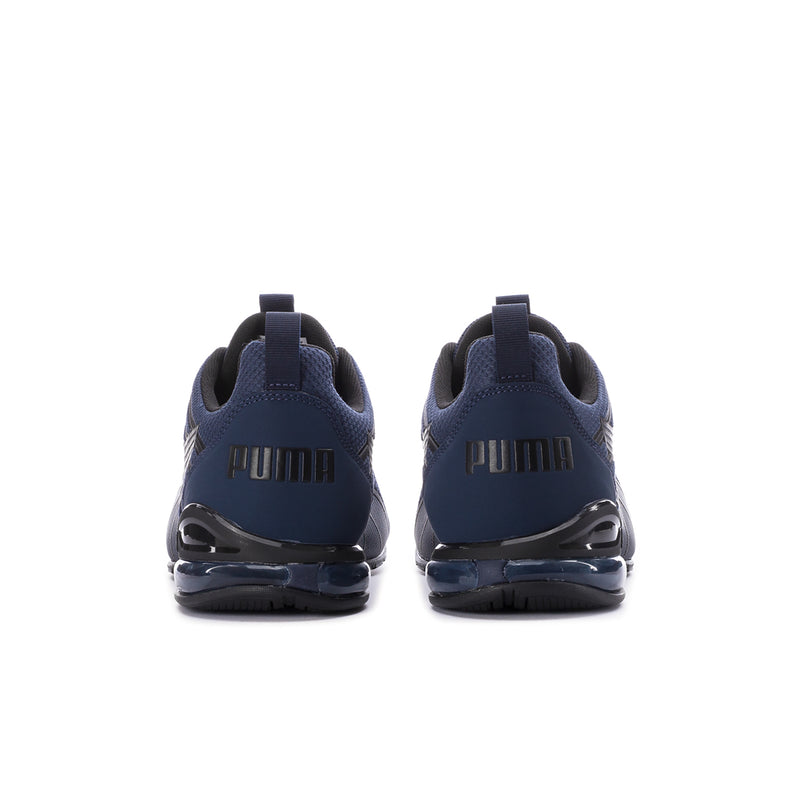 Navy sneakers with PUMA branding on heel and glossy air-cushion sole