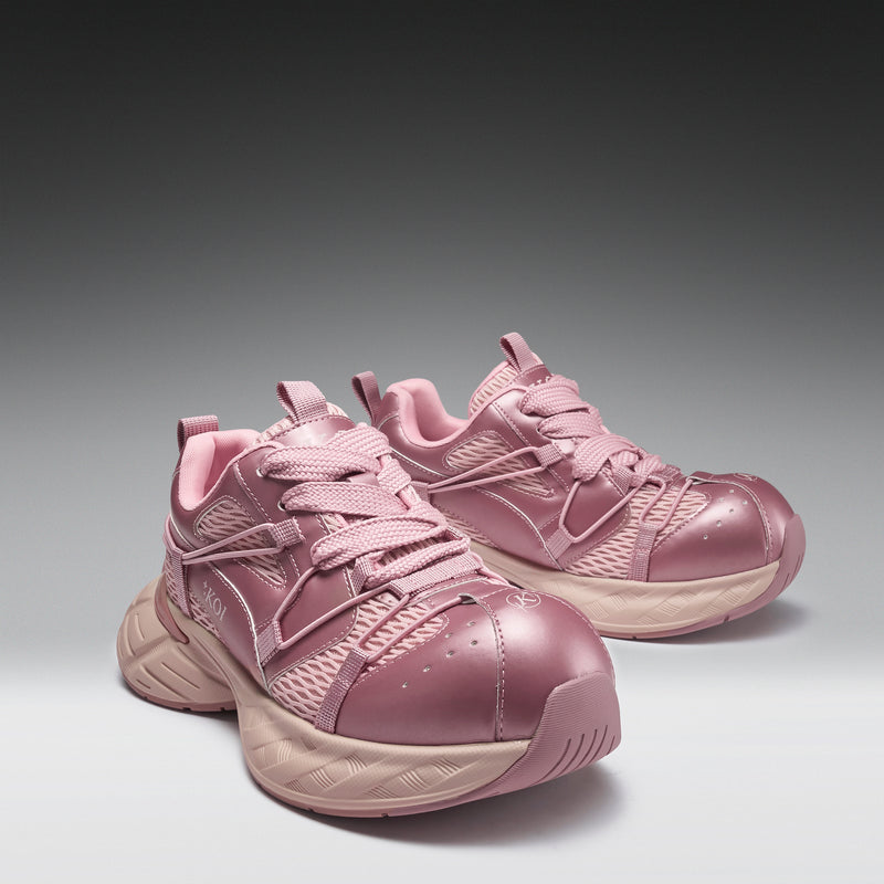 Pair of pink running shoes on a gray background