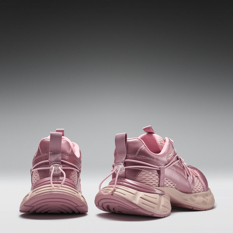 Pair of pink sneakers on a gray background