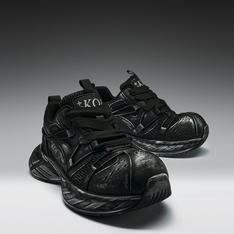 Pair of black sneakers on a gradient gray background