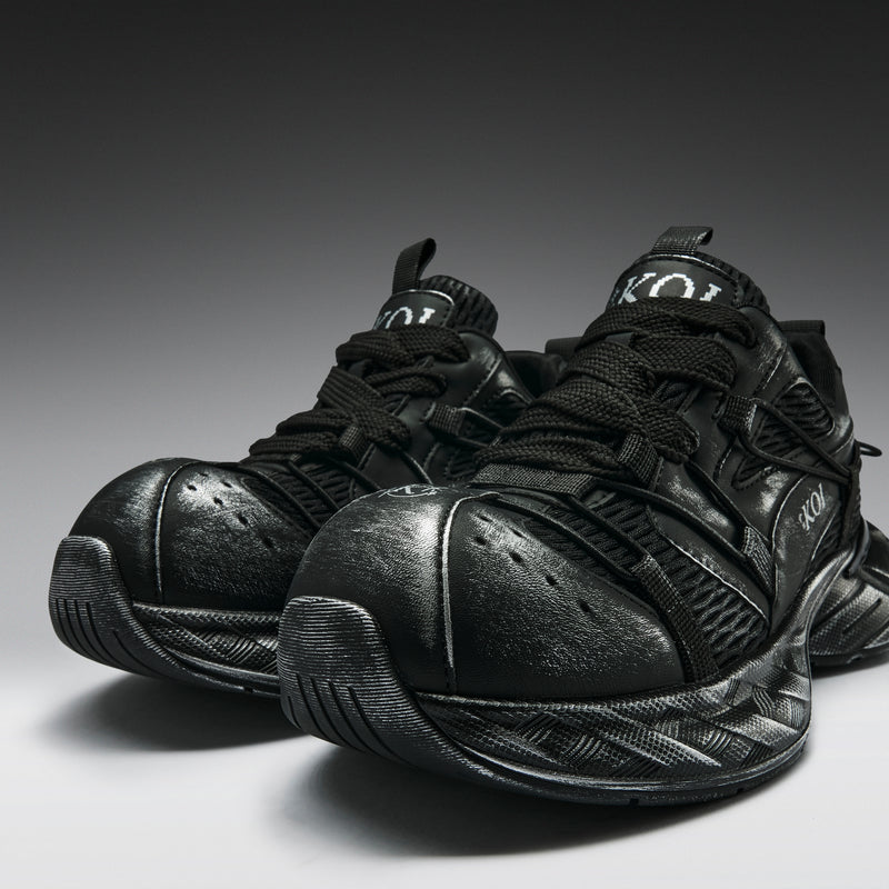 Pair of black sneakers on a gradient background