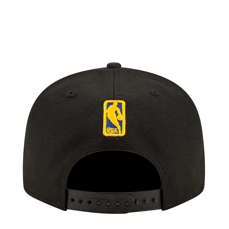 Black baseball cap with yellow on-back badge and ventilated panel holes