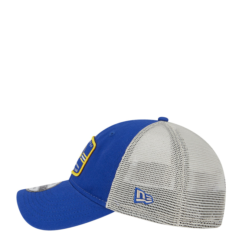 Blue trucker cap with white mesh side panel and “DB” logo patch; curved brim.