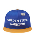 Blue satin baseball cap with yellow brim, white Golden State Warriors text