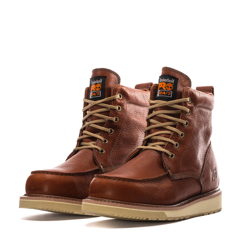 Pair of rust brown lace-up wedge boots with Timberland PS branding and tan soles
