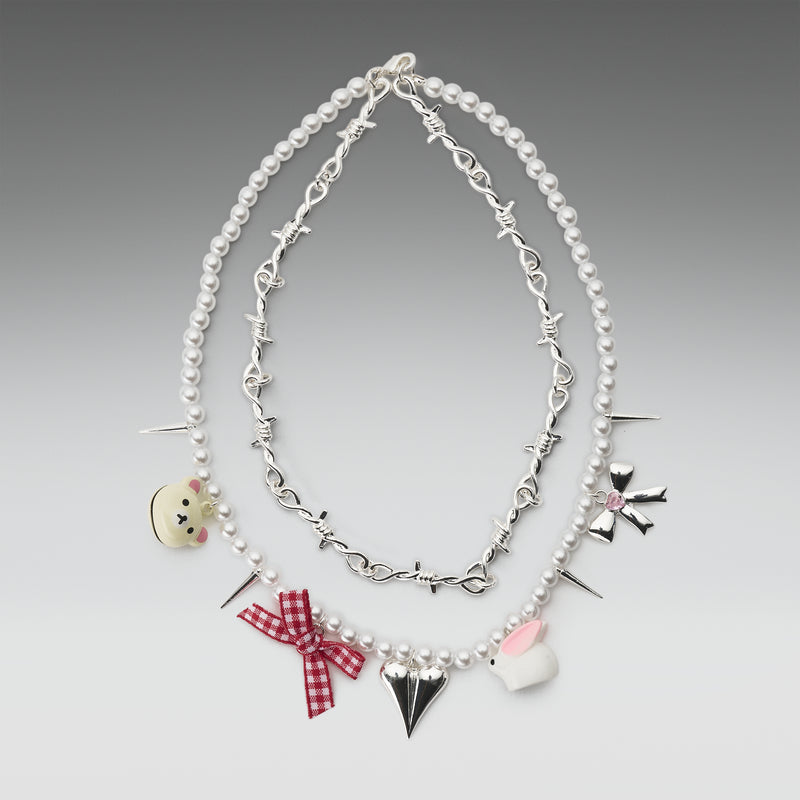Necklace with various charms on a gray background
