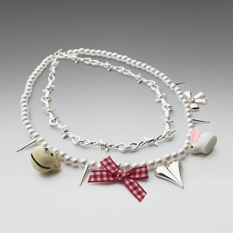 Necklace with various charms on a gray background