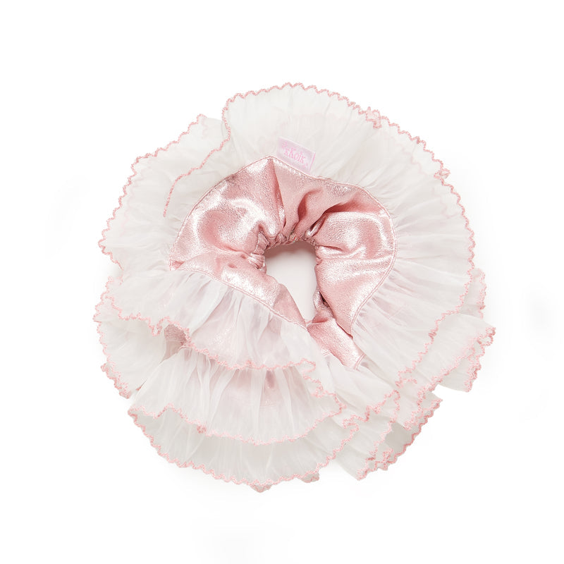 Pink and white ruffled headband with a bow on a white background