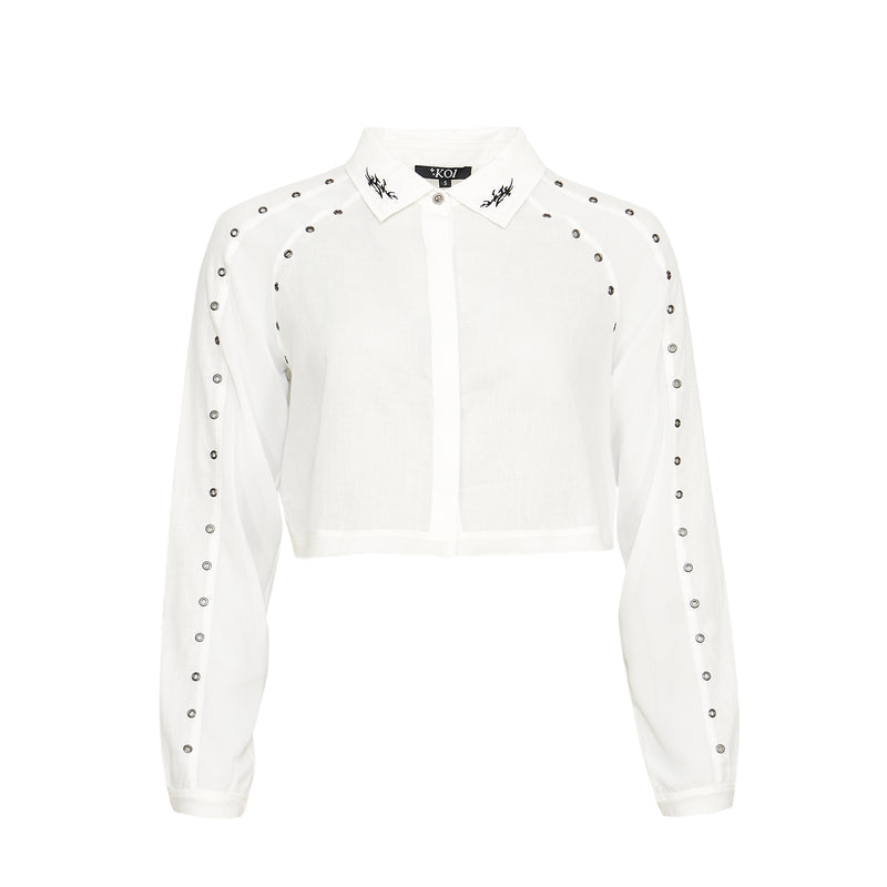 White blouse with black embellishments on a white background