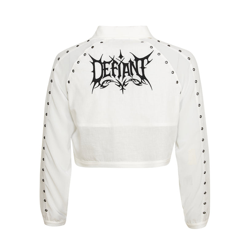White cropped jacket with black studded details and 'Defiant' logo on a white background
