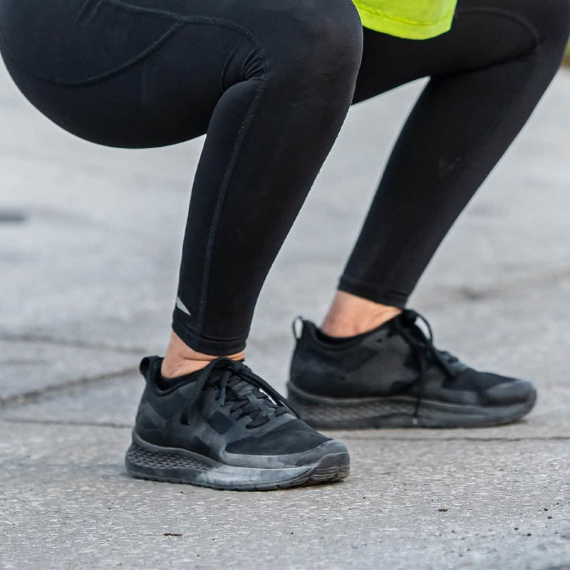 GORUCK rucking shoes in black worn outdoors during a squat exercise on pavement