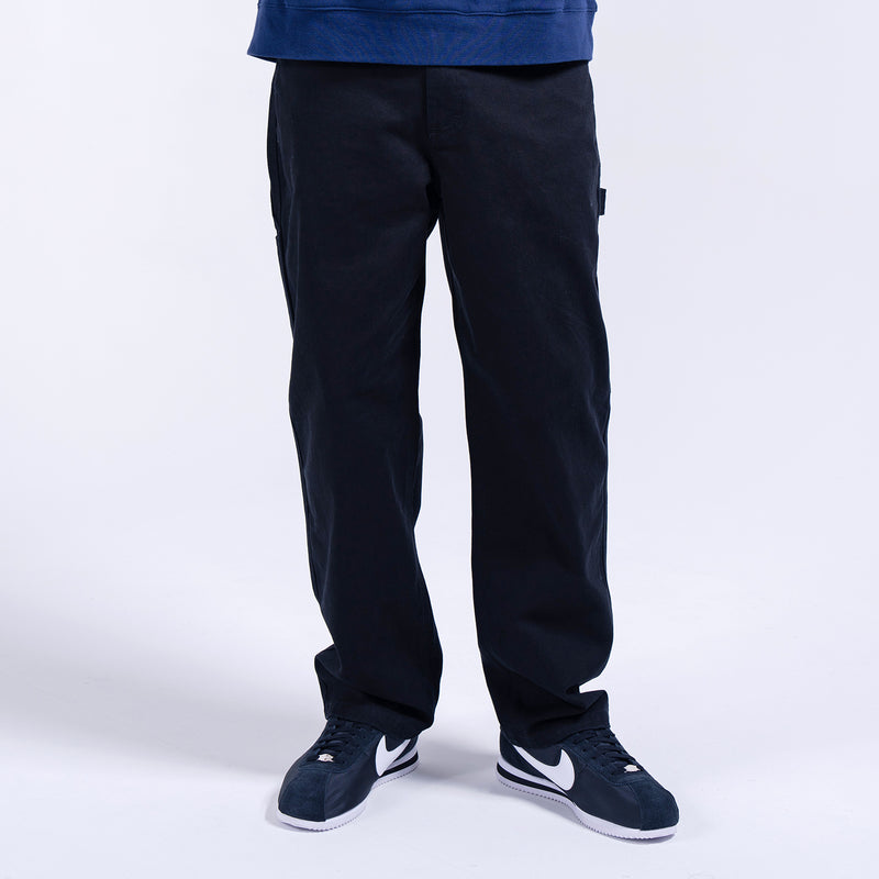Men's dark work pants with straight legs and multiple seam details