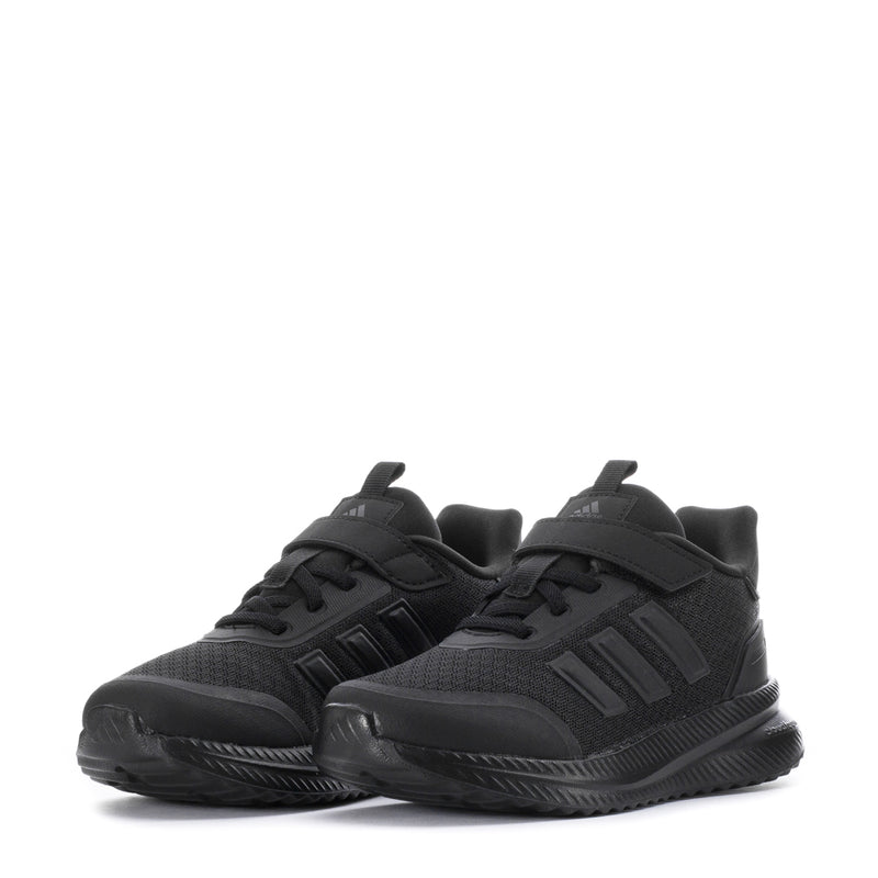 Pair of kids black sneakers with velcro strap and chunky patterned sole
