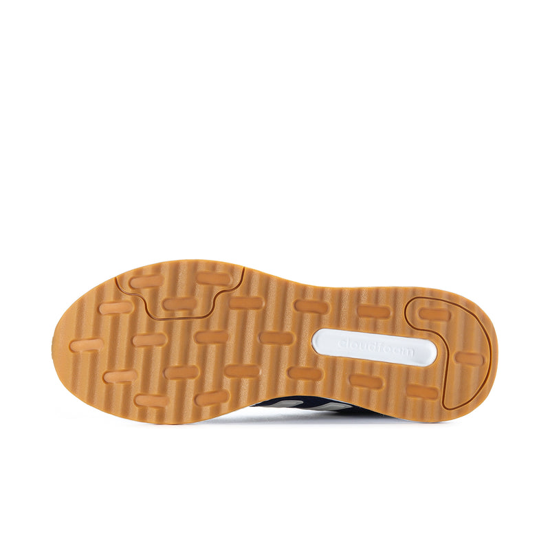 Shoe outsole view with gum rubber tread and white label on bottom