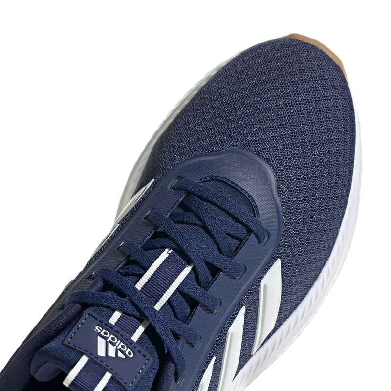 Close-up of men's navy lace-up sneaker with white stripes and adidas tongue branding