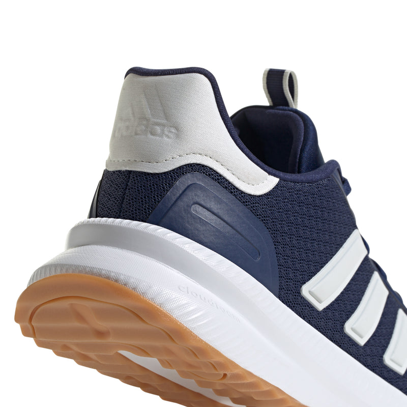 Close-up of men's navy heel and side panel with white stripes and cushioned collar