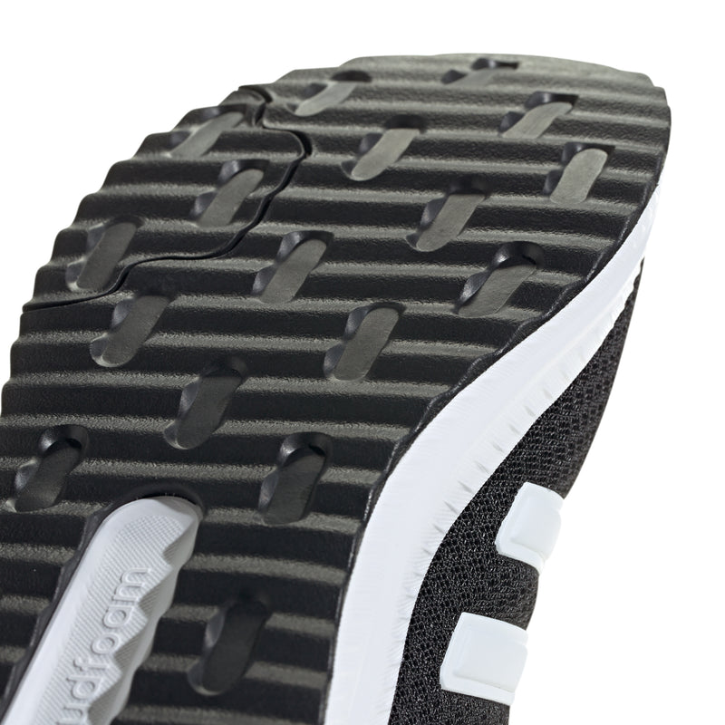 Close-up of men's black tread outsole and textured grip pattern with white edge trim