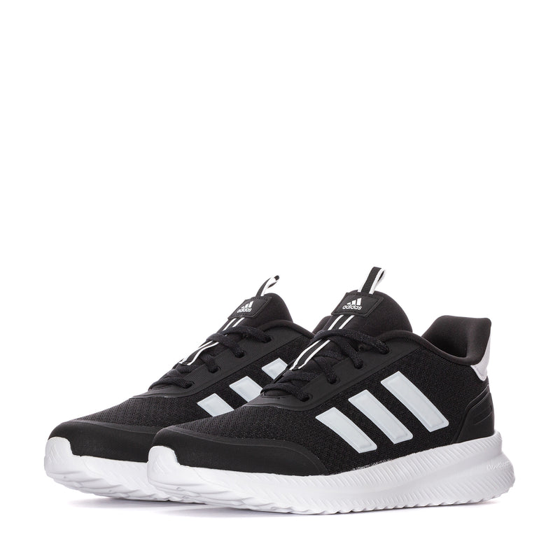 Pair of youth black adidas sneakers with white three-stripe detail and white midsoles