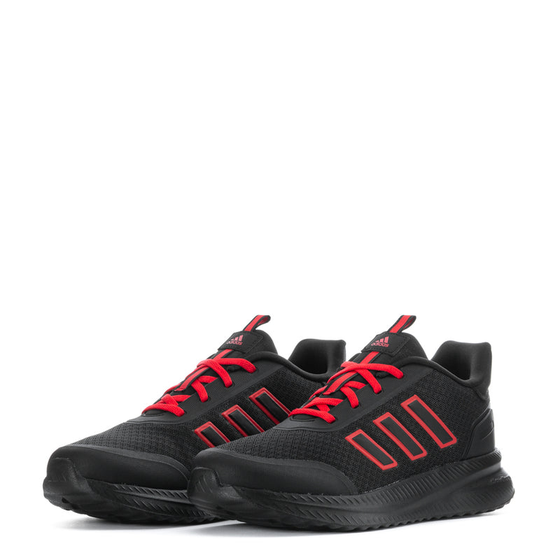 Pair of youth black sneakers with ruby red laces and chunky textured sole