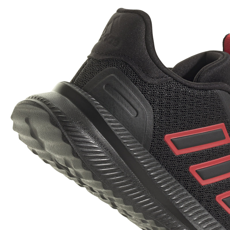Youth black sneaker with ruby red side stripe panel and textured traction sole