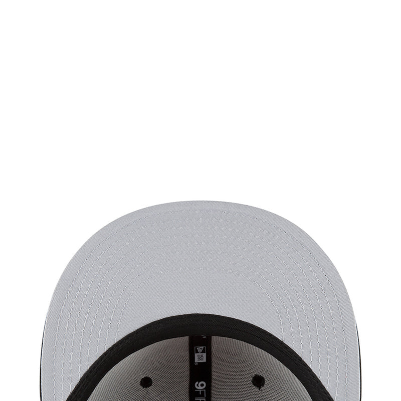 Light gray/white baseball cap close-up with black inner band and tag