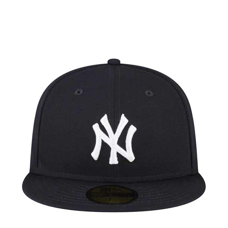 Dark baseball cap with white Yankees “NY” logo on the front panel