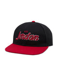 Youth snapback cap in black with red brim and AIR Jordan script