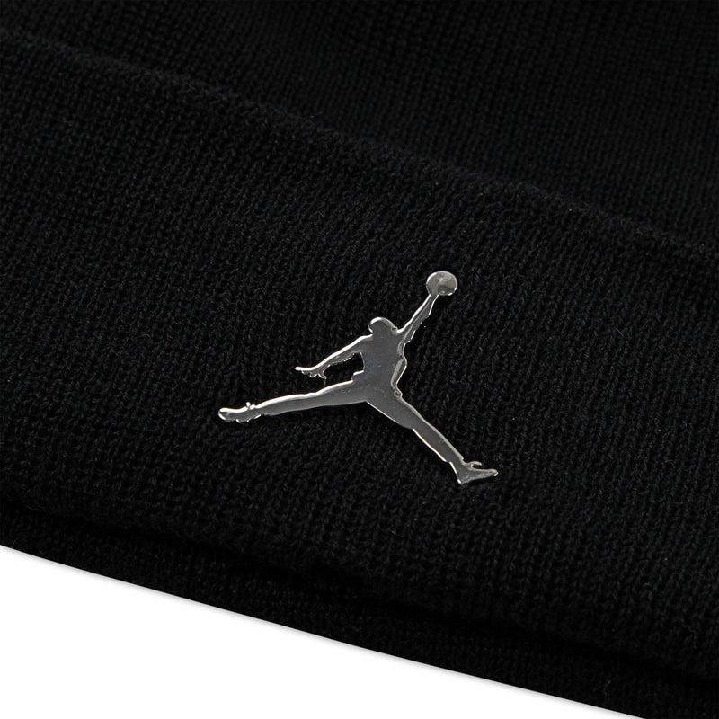 Black knit cuffed beanie with silver Jumpman logo close-up