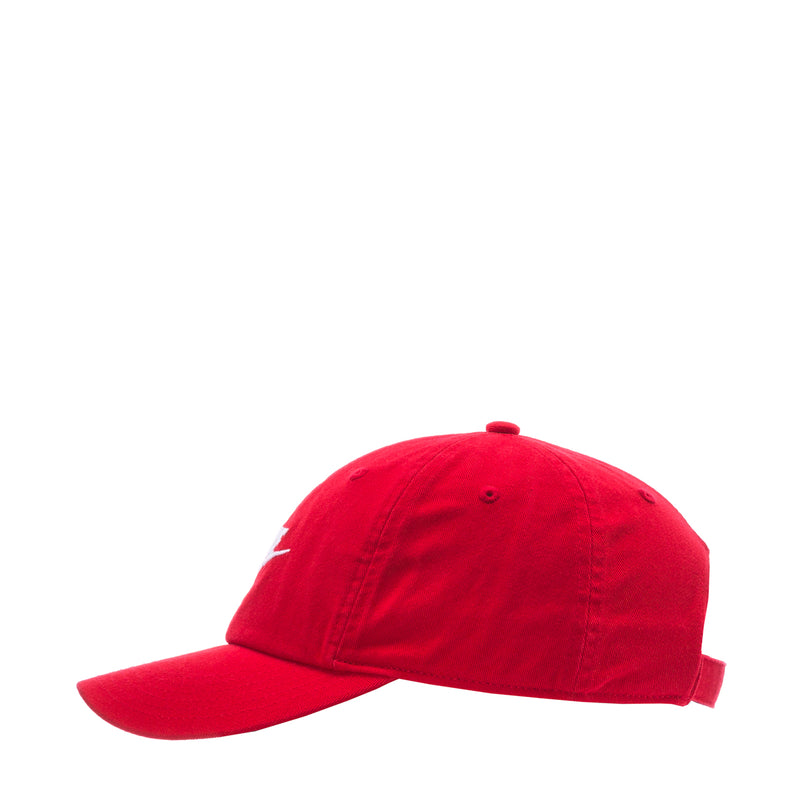 Youth red strapback cap, angled side view with white Nike logo mark