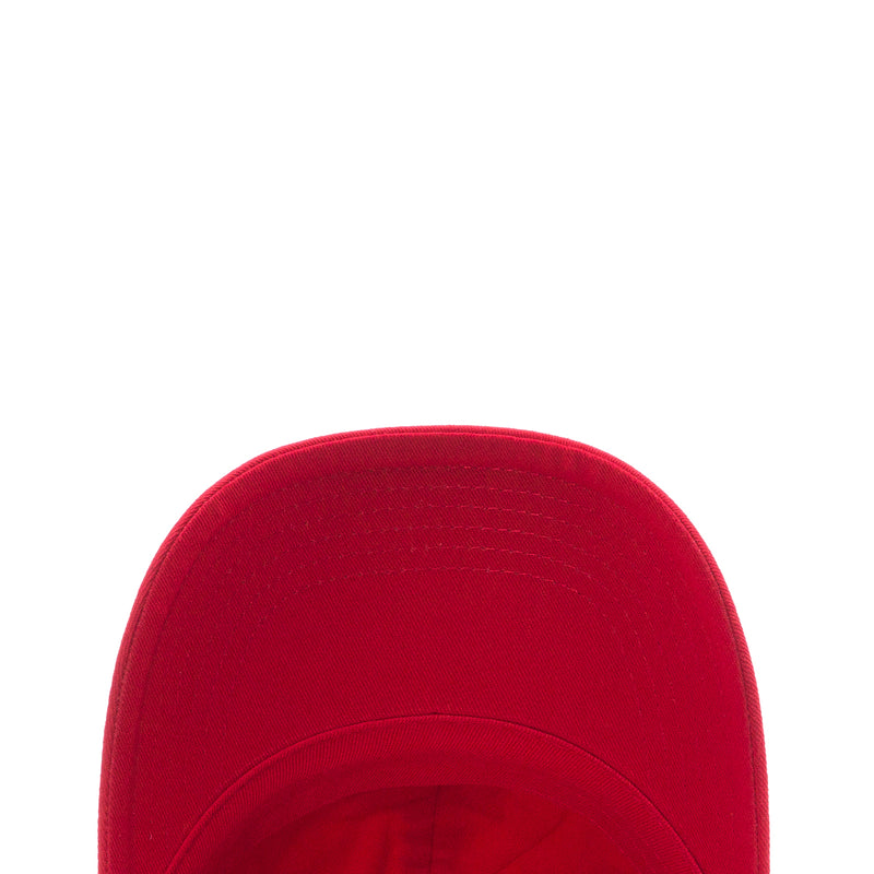 Youth red strapback cap crown close-up with curved seam stitching