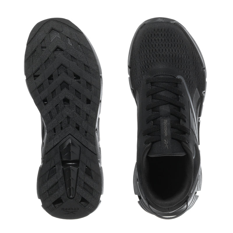 Pair of black youth sneakers with textured tread soles and lace-up toe view