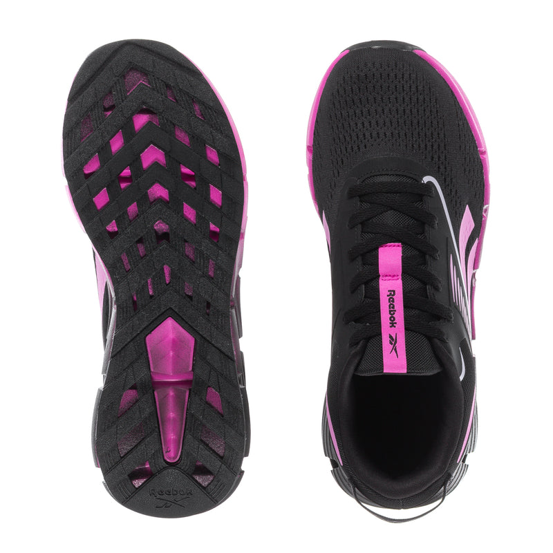Youth black sneakers with pink zigzag accents and treaded rubber outsole