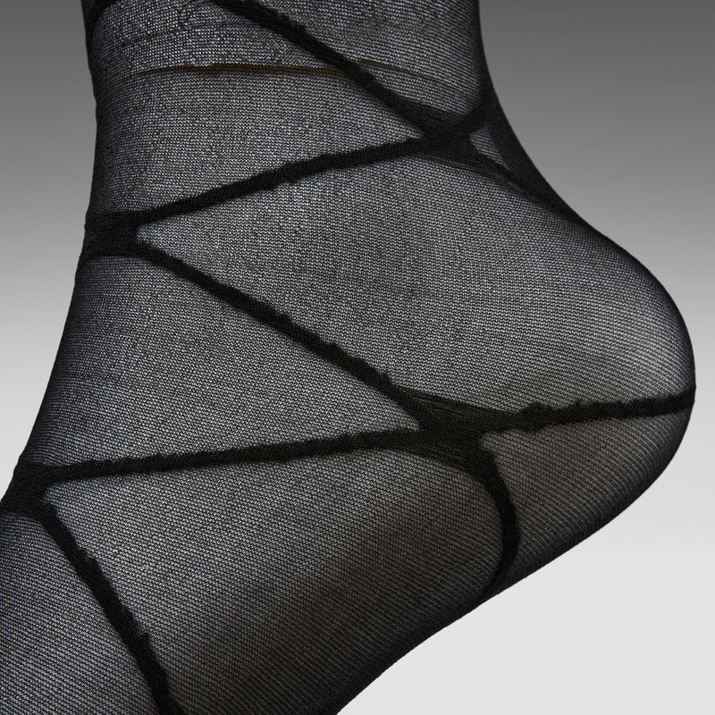 Black sheer sock on a gray background