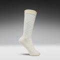 White knee-high sock with a subtle pattern on a gray background