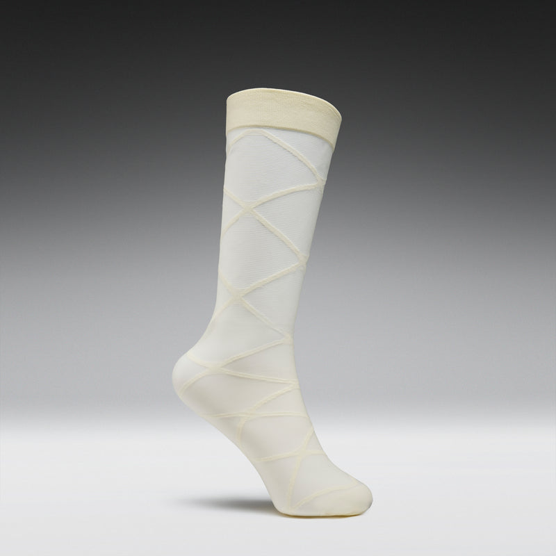 White knee-high sock with a subtle pattern on a gray background