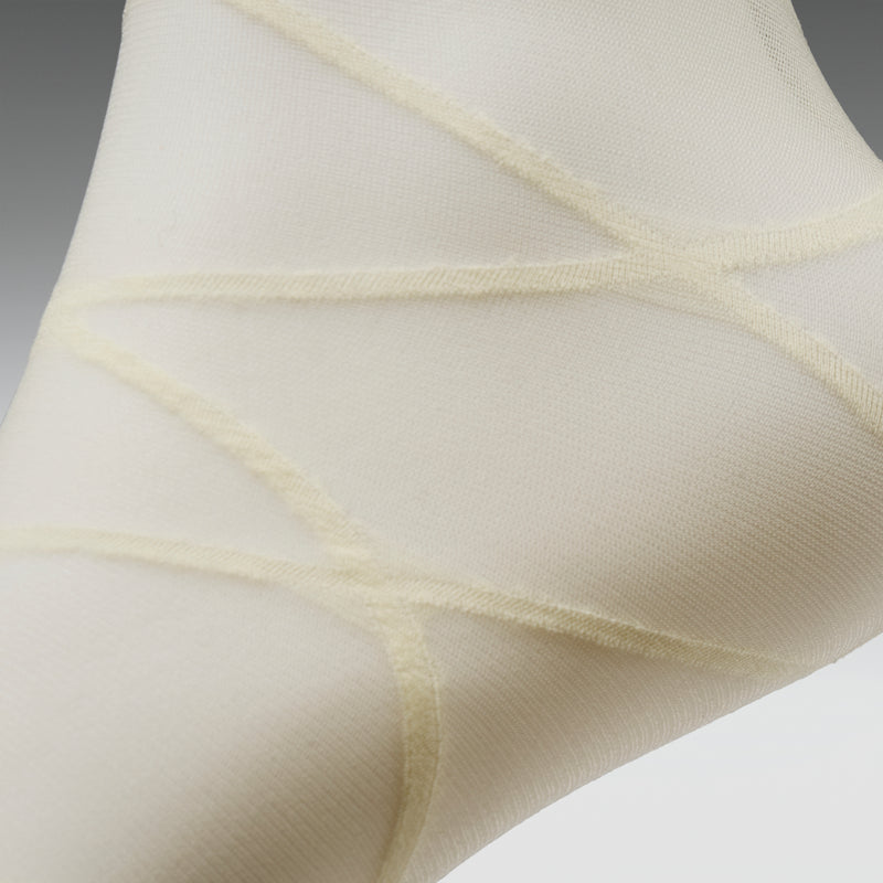 Close-up of beige sheer fabric on a light gray background